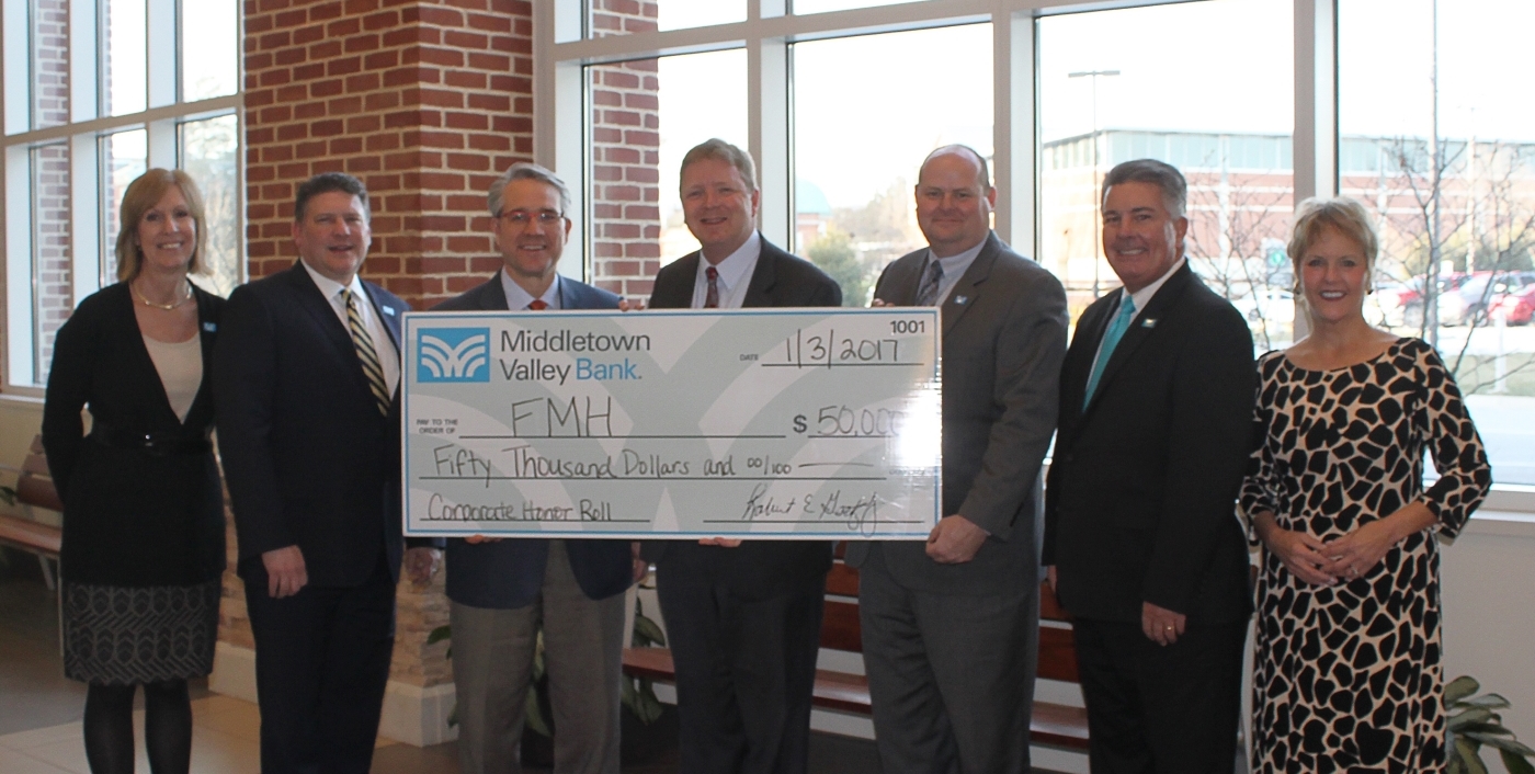 Group holding large check